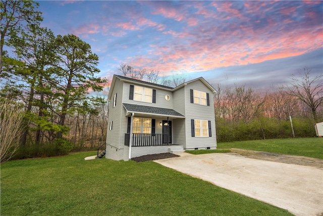 traditional-style home featuring crawl space, covered porch, driveway, and a yard