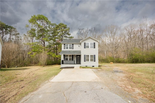 traditional-style home with crawl space, covered porch, driveway, and a front lawn