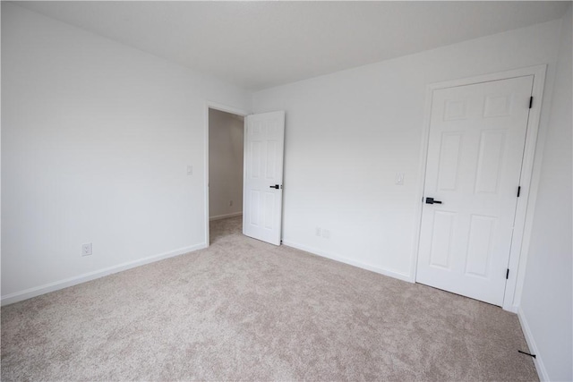 unfurnished bedroom featuring baseboards and carpet floors