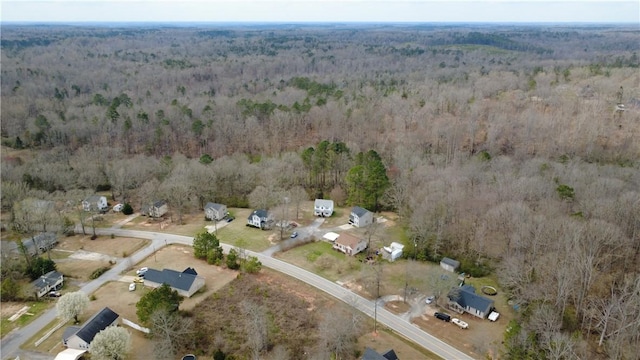 bird's eye view featuring a wooded view