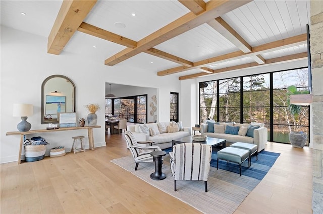 living room with recessed lighting, beamed ceiling, baseboards, and wood finished floors