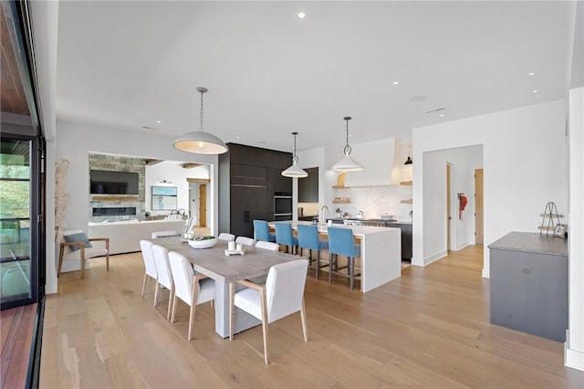 dining room featuring recessed lighting and light wood-type flooring