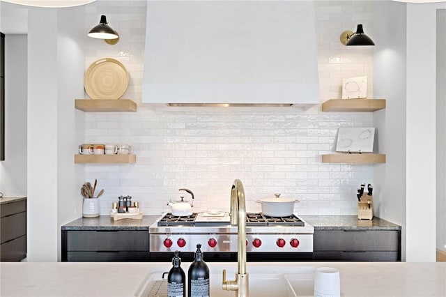 kitchen featuring open shelves, backsplash, custom exhaust hood, and stainless steel gas stovetop