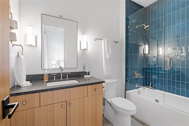 bathroom with vanity, toilet, tile patterned flooring, and bath / shower combo with glass door