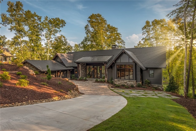 view of front of home with stone siding, a chimney, and a front yard