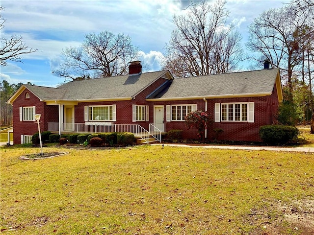 single story home featuring brick siding, a chimney, and a front lawn