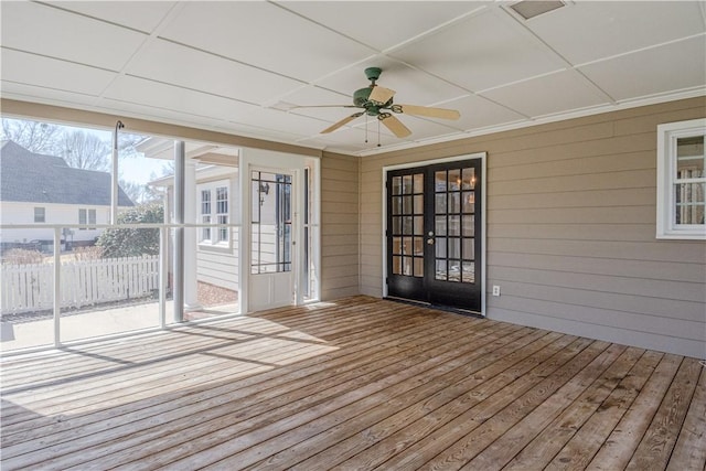 unfurnished sunroom featuring ceiling fan