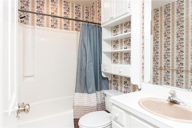 bathroom featuring vanity, shower / tub combo, and toilet