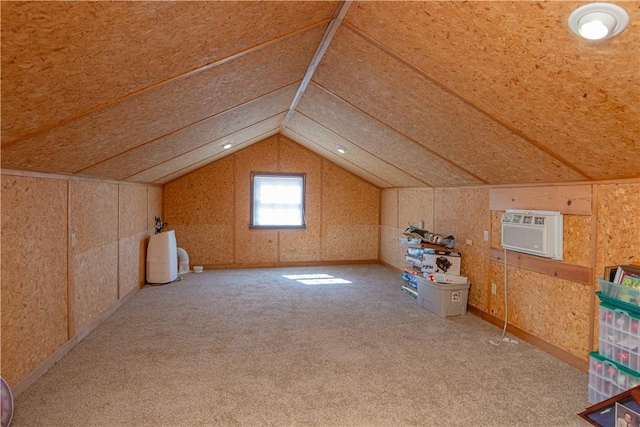 additional living space featuring a wall unit AC, carpet flooring, and lofted ceiling