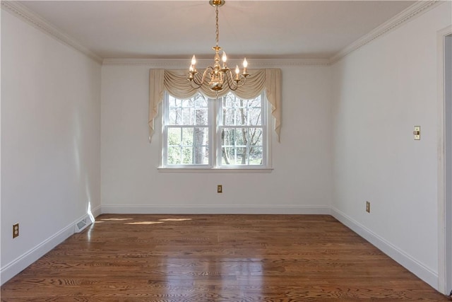 empty room featuring baseboards, a notable chandelier, wood finished floors, and ornamental molding