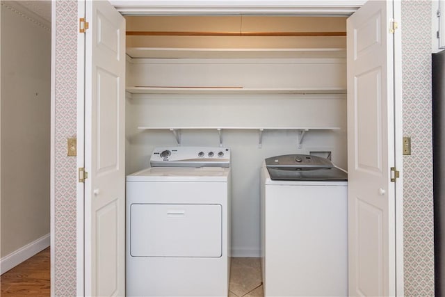 washroom with washer and clothes dryer, laundry area, and baseboards