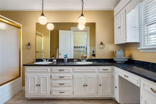 bathroom with double vanity, tile patterned floors, and a sink