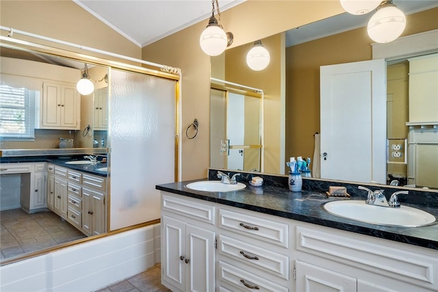 bathroom featuring a sink, lofted ceiling, and crown molding