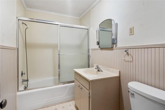 bathroom with toilet, ornamental molding, wainscoting, tile patterned floors, and enclosed tub / shower combo