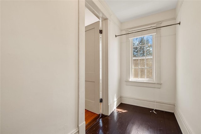 interior space featuring baseboards and hardwood / wood-style flooring