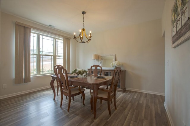 dining area featuring visible vents, baseboards, a chandelier, and dark wood-style flooring