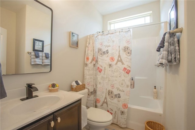 bathroom with toilet, vanity, and shower / bath combo