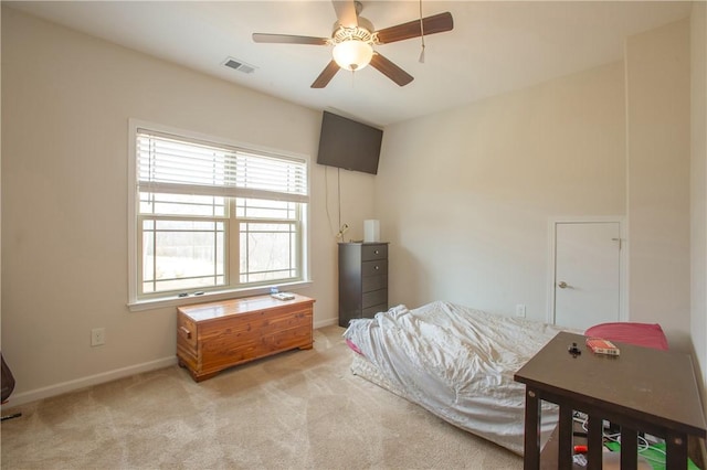 bedroom with visible vents, baseboards, light colored carpet, and ceiling fan