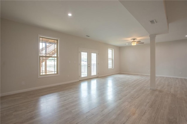 empty room with visible vents, baseboards, light wood-style floors, and ceiling fan