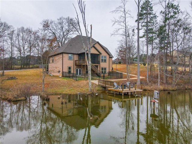 dock area with a deck with water view and stairs