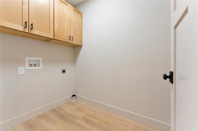 laundry area featuring baseboards, hookup for a washing machine, light wood-style floors, cabinet space, and hookup for an electric dryer