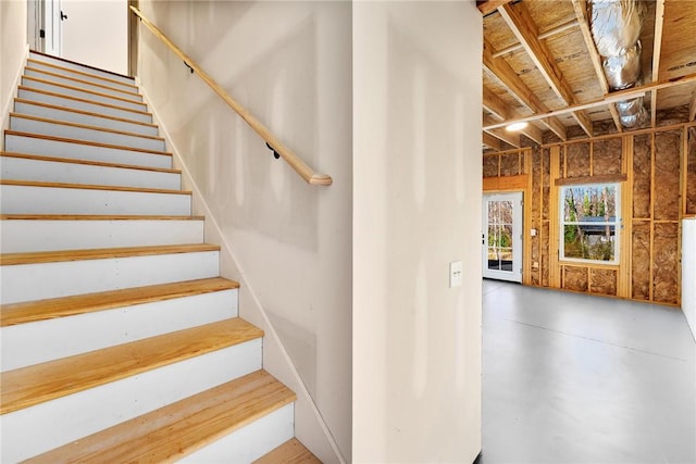 stairway featuring finished concrete floors