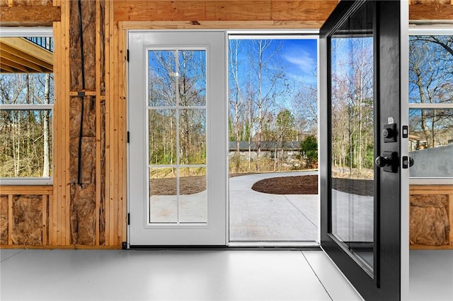 doorway to outside featuring concrete flooring