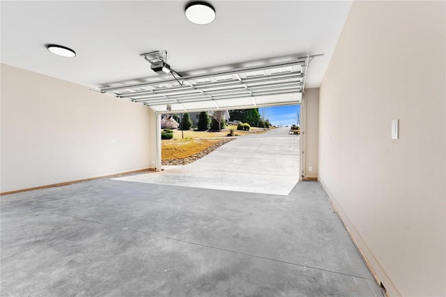 garage with baseboards and a garage door opener