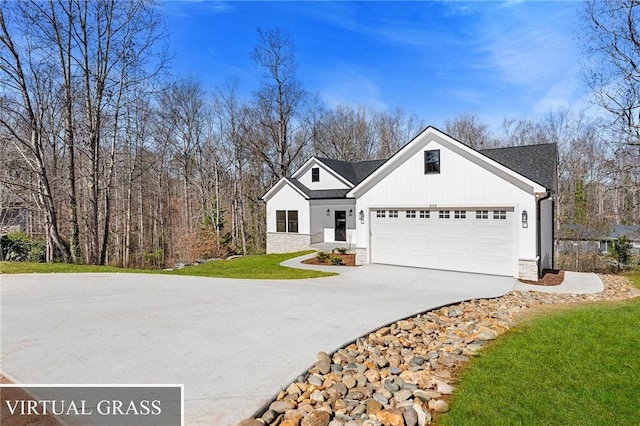 view of front of home with a garage, a front yard, and driveway