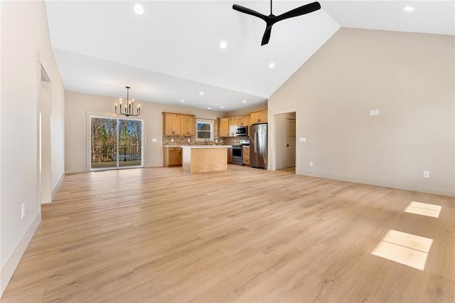 unfurnished living room featuring baseboards, light wood-type flooring, recessed lighting, ceiling fan with notable chandelier, and high vaulted ceiling