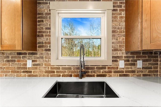 interior details featuring light countertops and a sink