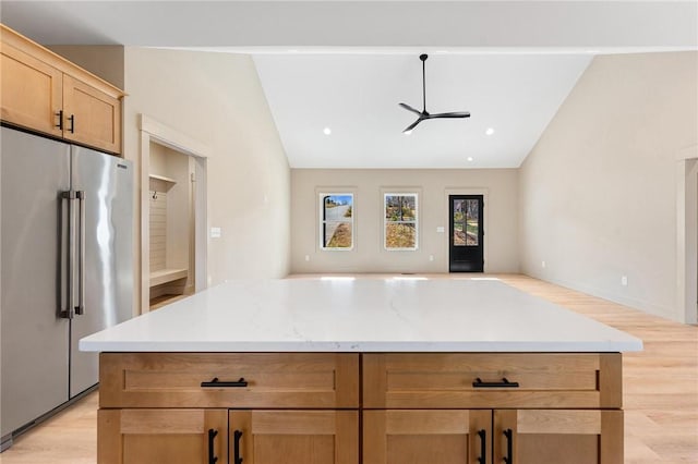 kitchen with lofted ceiling, open floor plan, a ceiling fan, and high end fridge