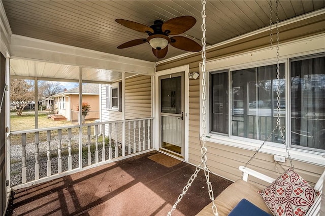 unfurnished sunroom with wood ceiling and ceiling fan