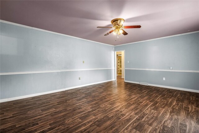 empty room with baseboards, wood finished floors, a ceiling fan, and ornamental molding