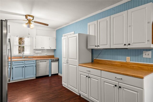 kitchen featuring a ceiling fan, a sink, white cabinetry, appliances with stainless steel finishes, and dark wood-style flooring