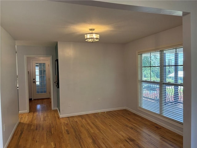115 Morgan Rd, West Union, SC 29696 - unfurnished room featuring baseboards, healthy amount of natural light, wood finished floors, and a chandelier