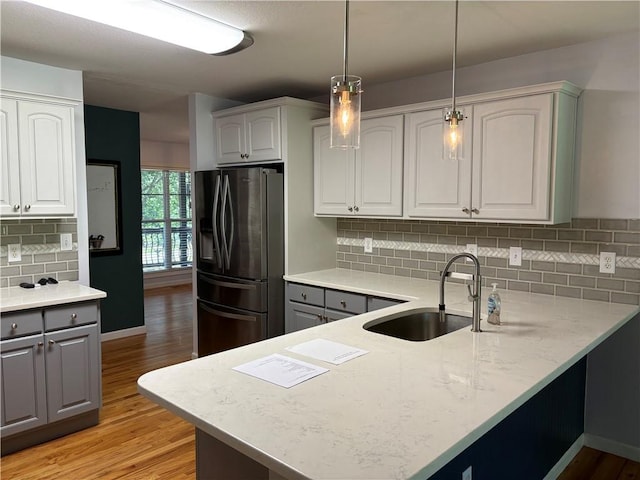115 Morgan Rd, West Union, SC 29696 - kitchen featuring stainless steel fridge with ice dispenser, a sink, a peninsula, and light wood-type flooring