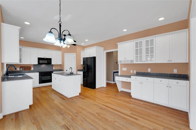 523 Heron Cove Cir, Seneca, SC 29672 - kitchen with black appliances, a sink, dark countertops, light wood-type flooring, and recessed lighting