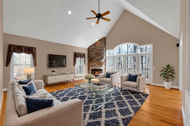 523 Heron Cove Cir, Seneca, SC 29672 - living room with high vaulted ceiling, ceiling fan, a fireplace, light wood-style floors, and baseboards
