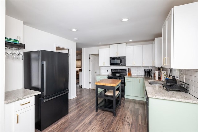 107 Berkley Ave, Greenville, SC 29609 - kitchen with decorative backsplash, black appliances, and dark wood-style flooring