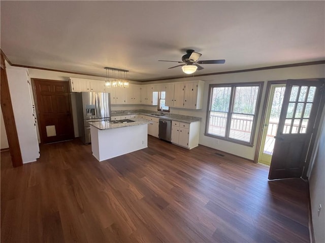 236 Issaqueena Dr, Central, SC 29630 - kitchen with stainless steel appliances, white cabinets, dark wood-style floors, and ornamental molding