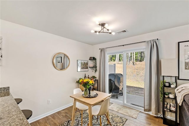 511 Oakmont Valley Trl, Seneca, SC 29678 - dining space with baseboards, wood finished floors, a notable chandelier, and visible vents