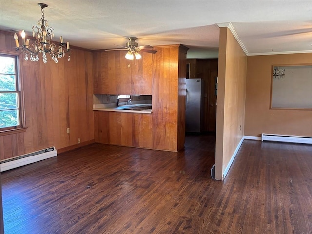 kitchen with a baseboard radiator, dark wood finished floors, brown cabinetry, and freestanding refrigerator