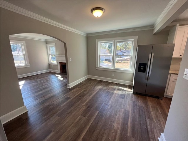 304 Oak Dr, Anderson, SC 29625 - unfurnished dining area featuring ornamental molding, arched walkways, and dark wood finished floors