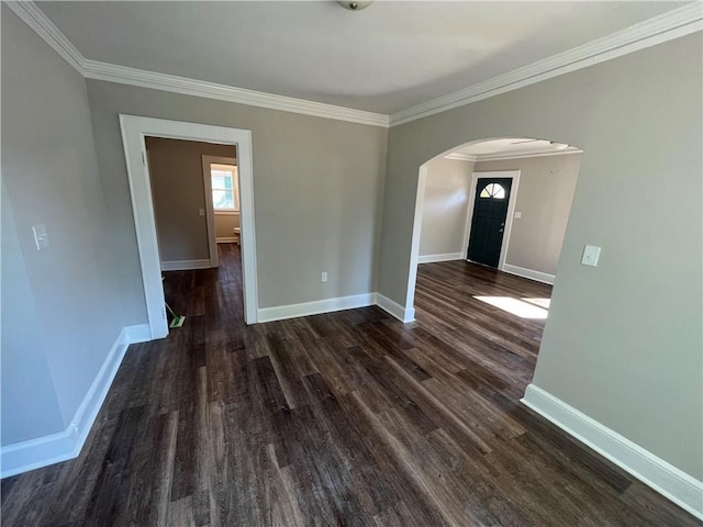 304 Oak Dr, Anderson, SC 29625 - unfurnished room featuring baseboards, crown molding, arched walkways, and dark wood-style flooring