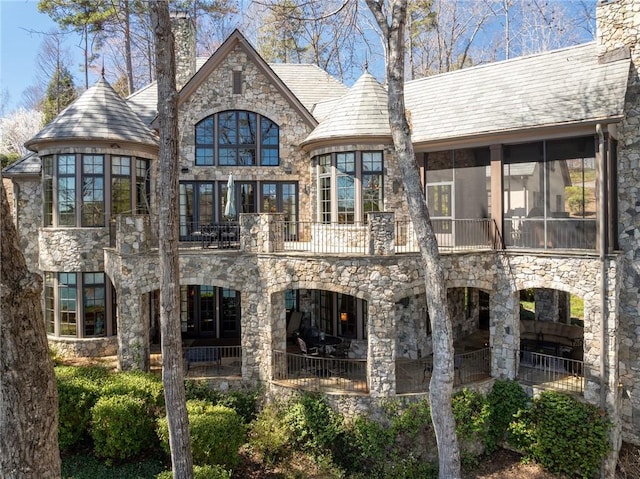 136 Blue Water Trl, Salem, SC 29676 - back of house with stone siding, a balcony, a chimney, and a sunroom
