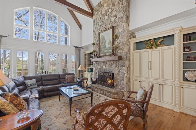 136 Blue Water Trl, Salem, SC 29676 - living room featuring beam ceiling, a healthy amount of sunlight, a fireplace, and light wood-style floors