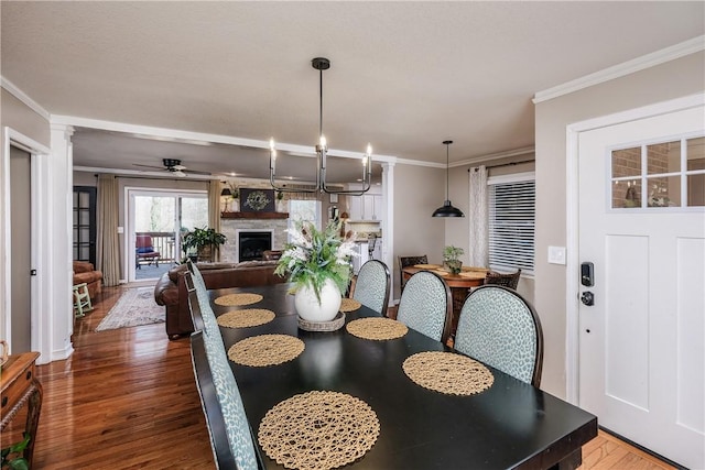 115 Pine Forest Dr, Easley, SC 29642 - dining room with wood finished floors, a ceiling fan, ornamental molding, and a fireplace