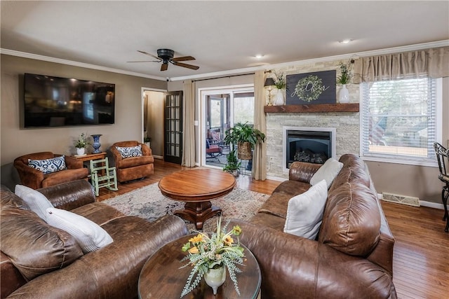 115 Pine Forest Dr, Easley, SC 29642 - living room featuring wood finished floors, baseboards, ornamental molding, a stone fireplace, and ceiling fan