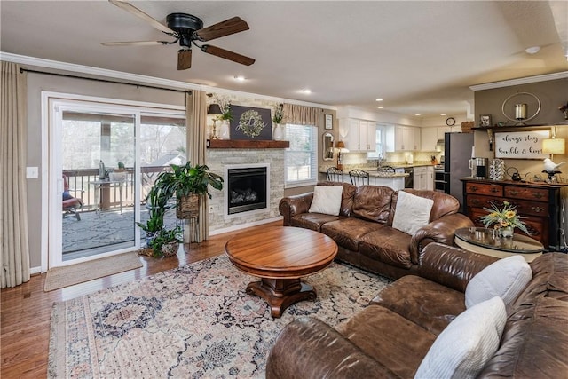 115 Pine Forest Dr, Easley, SC 29642 - living room with ornamental molding, a stone fireplace, recessed lighting, wood finished floors, and a ceiling fan